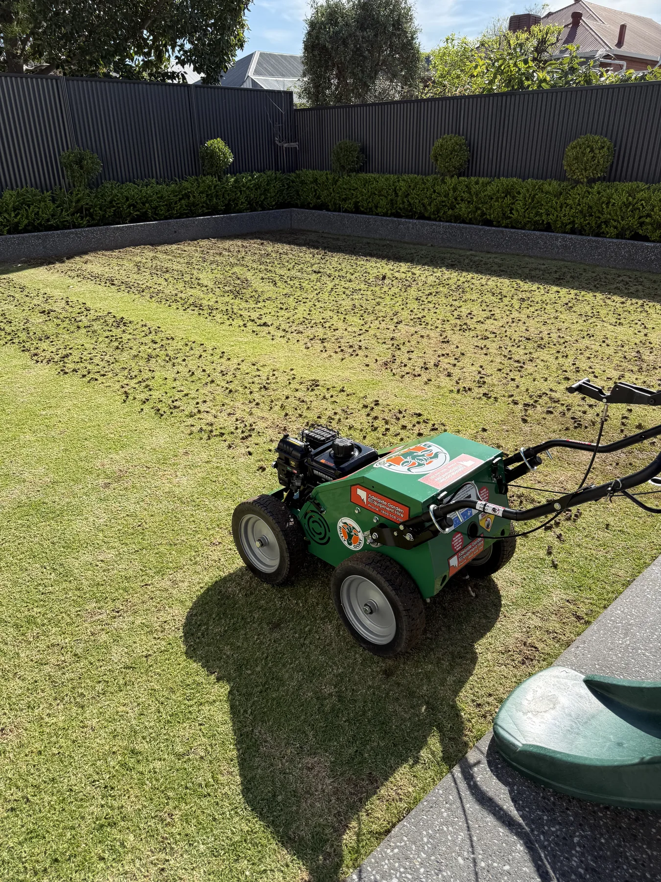Billy Goat aerator coring a lawn